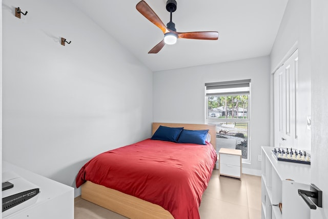 bedroom featuring a closet, vaulted ceiling, and ceiling fan