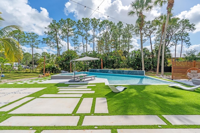 view of swimming pool featuring a patio and a lawn