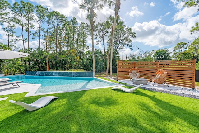 view of pool with a yard