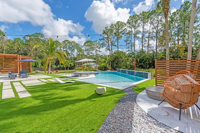 view of swimming pool featuring a lawn and a patio area