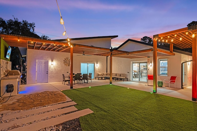 back house at dusk featuring a yard, a pergola, and a patio area