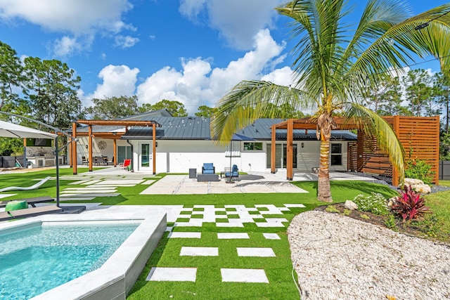 rear view of house featuring a lawn and a patio area