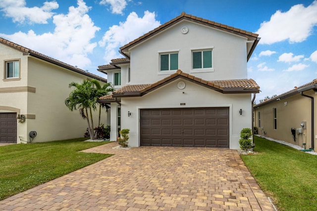 mediterranean / spanish-style house featuring a garage and a front lawn