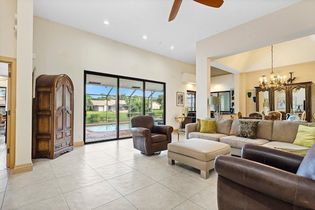 tiled living room featuring ceiling fan with notable chandelier