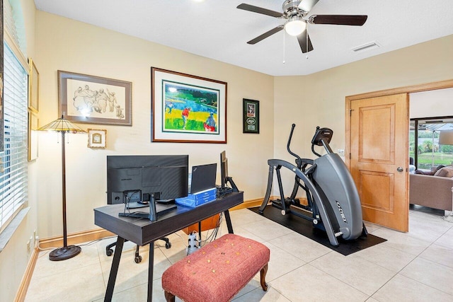 home office with light tile patterned floors and ceiling fan