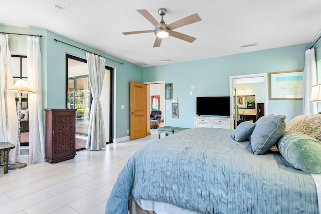 bedroom with a textured ceiling and ceiling fan