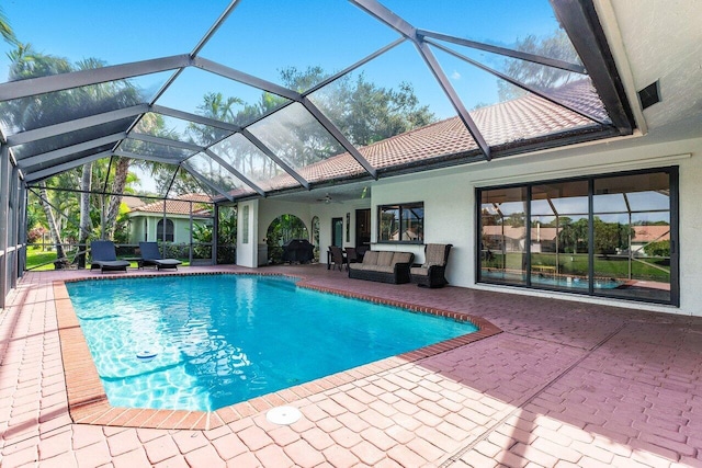 view of swimming pool with a lanai, an outdoor hangout area, ceiling fan, and a patio area