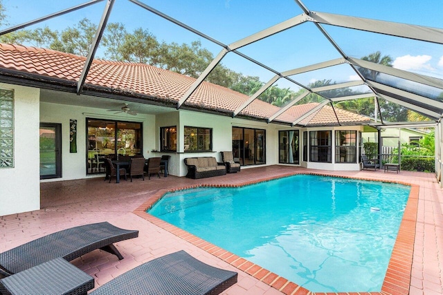 view of swimming pool with a patio, an outdoor hangout area, ceiling fan, and a lanai