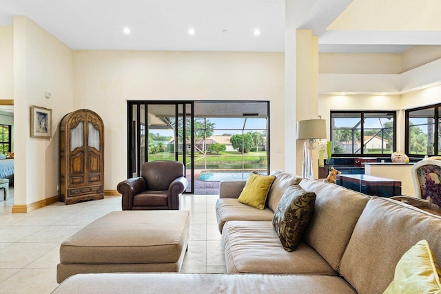 living room featuring light tile patterned flooring and a towering ceiling