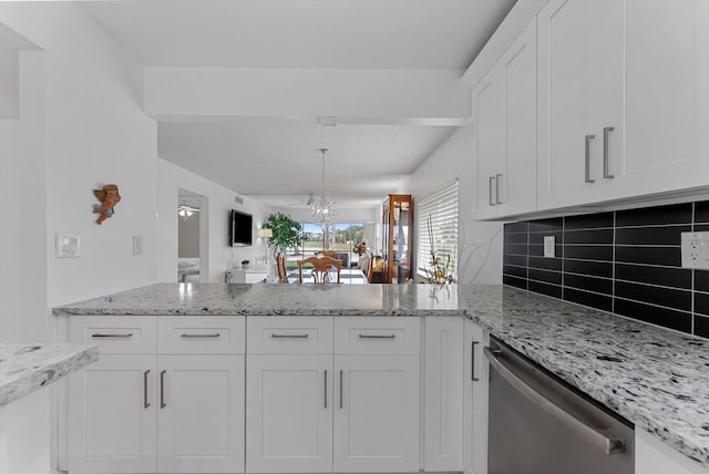 kitchen featuring backsplash, white cabinetry, a notable chandelier, light stone countertops, and dishwasher