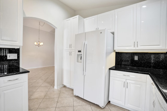 kitchen featuring tasteful backsplash, light tile patterned floors, white fridge with ice dispenser, lofted ceiling, and white cabinets