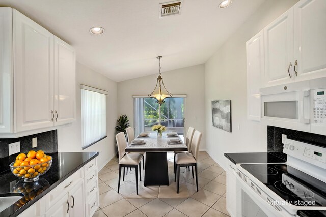 dining space with vaulted ceiling, recessed lighting, a chandelier, light tile patterned floors, and baseboards