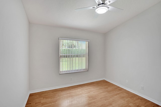 empty room featuring ceiling fan and light hardwood / wood-style flooring