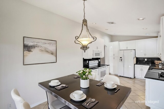 dining area with light tile patterned floors and recessed lighting