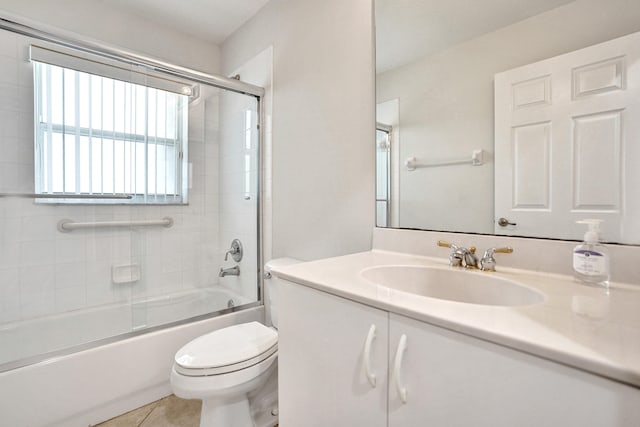 full bathroom with enclosed tub / shower combo, tile patterned floors, toilet, and vanity