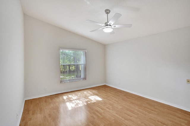 empty room featuring ceiling fan, lofted ceiling, and light hardwood / wood-style floors