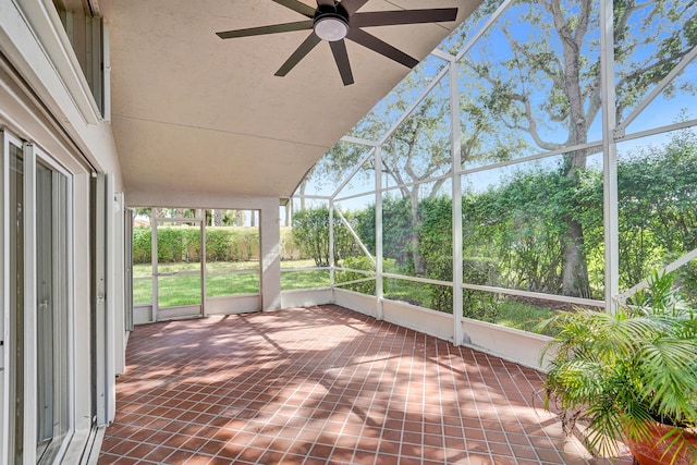 unfurnished sunroom featuring ceiling fan