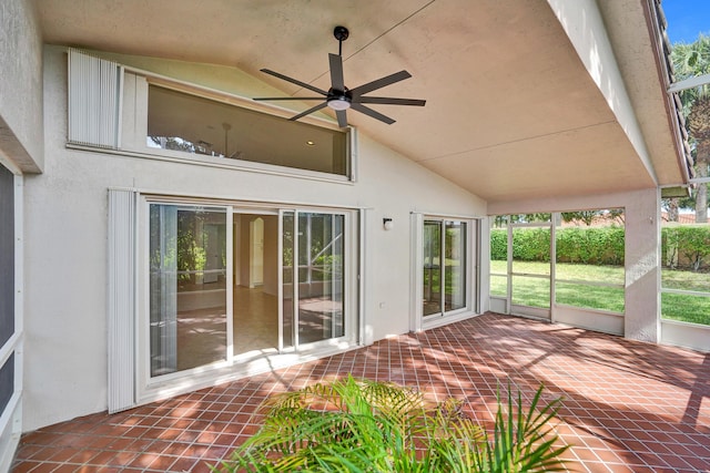 unfurnished sunroom with high vaulted ceiling, a ceiling fan, and tile patterned floors