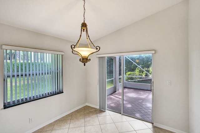 unfurnished dining area featuring light tile patterned floors and lofted ceiling