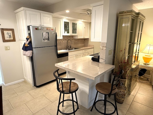 kitchen featuring white cabinets, sink, and appliances with stainless steel finishes