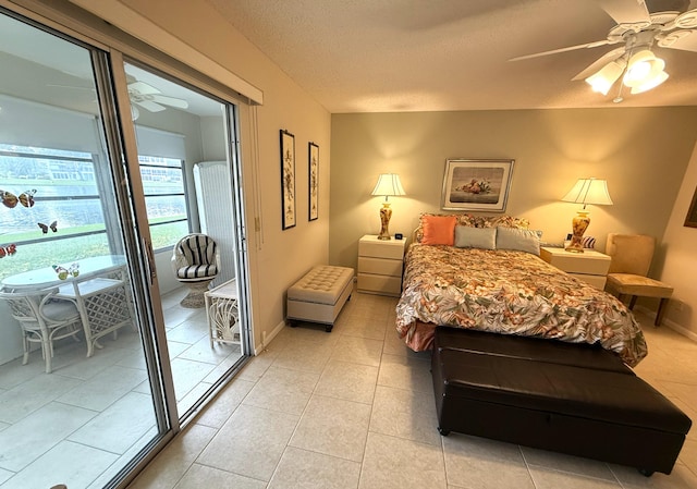 bedroom featuring a textured ceiling, light tile patterned floors, and ceiling fan