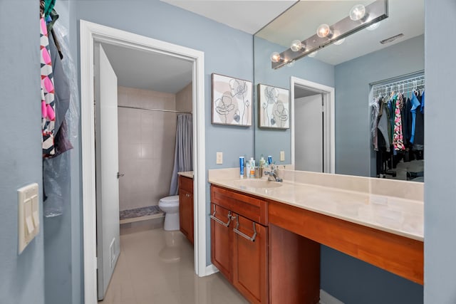 bathroom with tile patterned flooring, vanity, a shower with shower curtain, and toilet