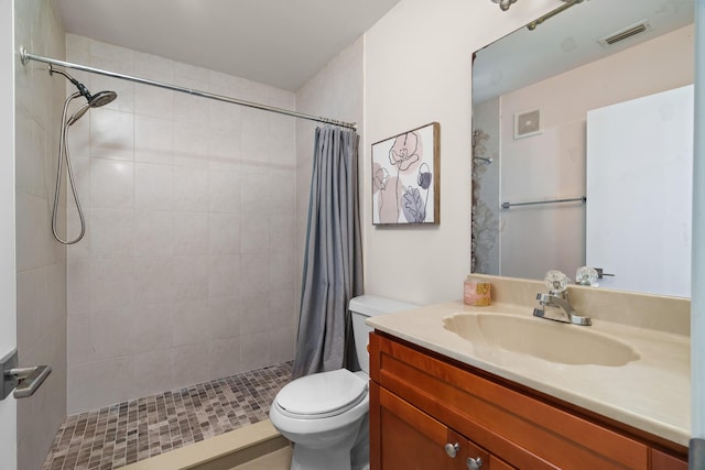 bathroom with a shower with curtain, vanity, and toilet