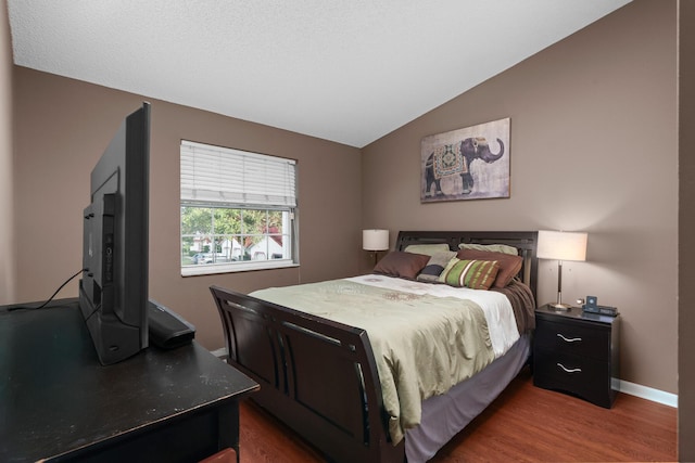 bedroom with dark hardwood / wood-style floors and vaulted ceiling