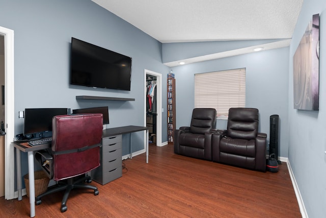 home office featuring a textured ceiling, lofted ceiling, and dark wood-type flooring