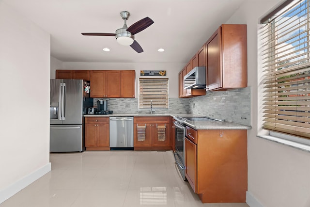 kitchen with decorative backsplash, light tile patterned flooring, sink, and appliances with stainless steel finishes