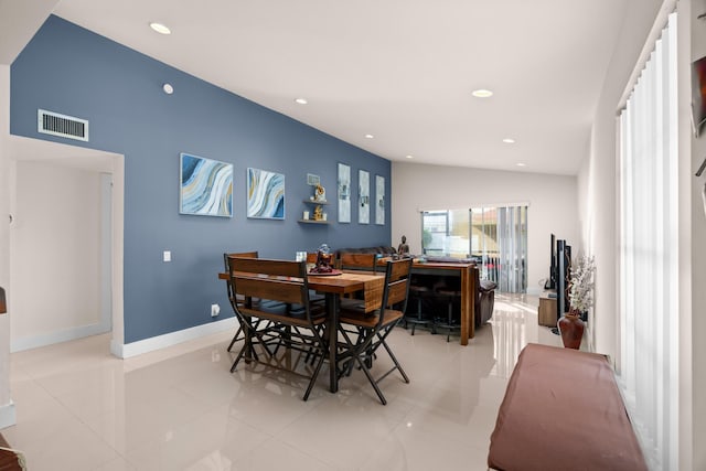 dining room with light tile patterned flooring and lofted ceiling