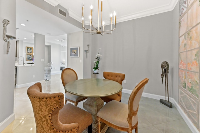 dining room featuring crown molding, sink, light tile patterned flooring, and a chandelier