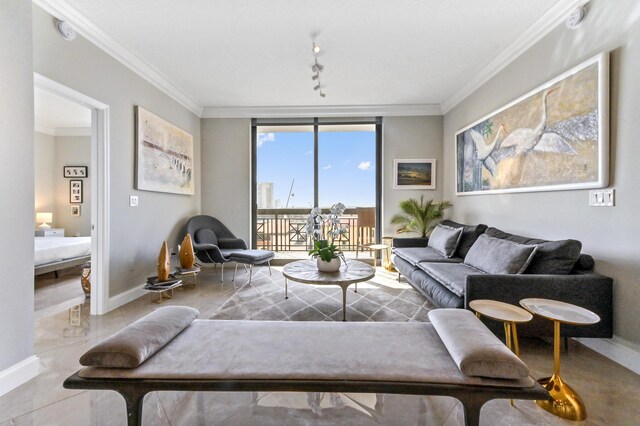 living room featuring rail lighting, floor to ceiling windows, and ornamental molding