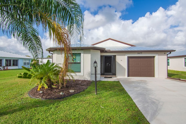 view of front of home with a garage and a front yard