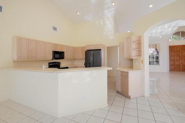 kitchen featuring kitchen peninsula, light tile patterned floors, high vaulted ceiling, and black appliances