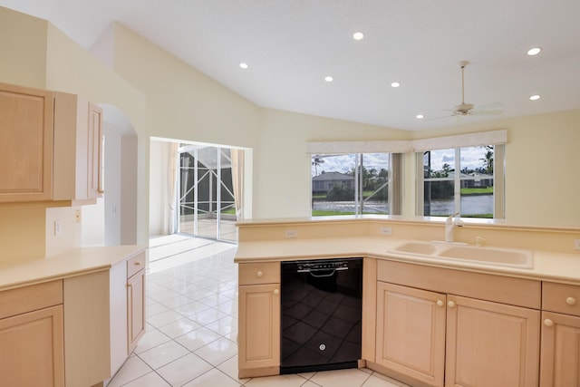 kitchen with ceiling fan, sink, light brown cabinets, black dishwasher, and vaulted ceiling