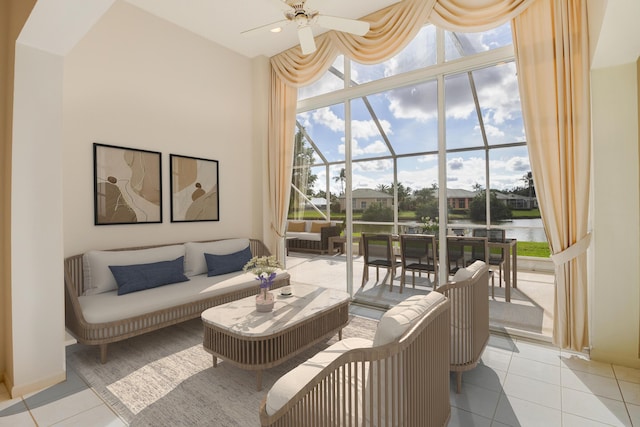 living room with light tile patterned floors, a water view, expansive windows, and ceiling fan