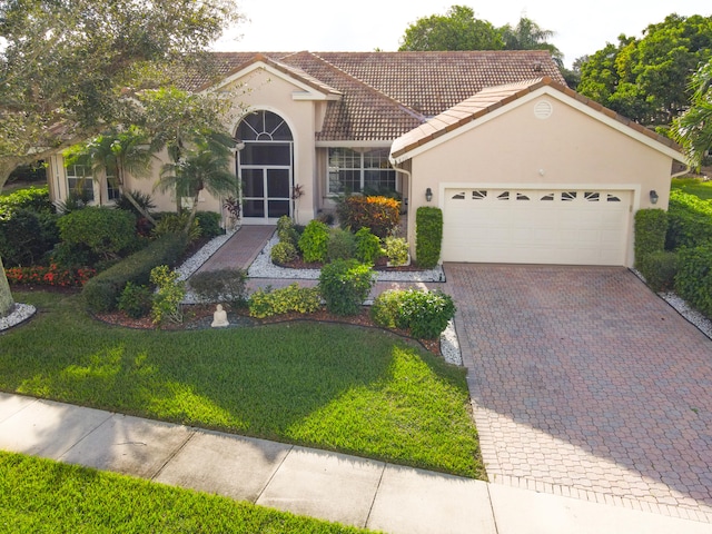 view of front of property featuring a garage and a front yard