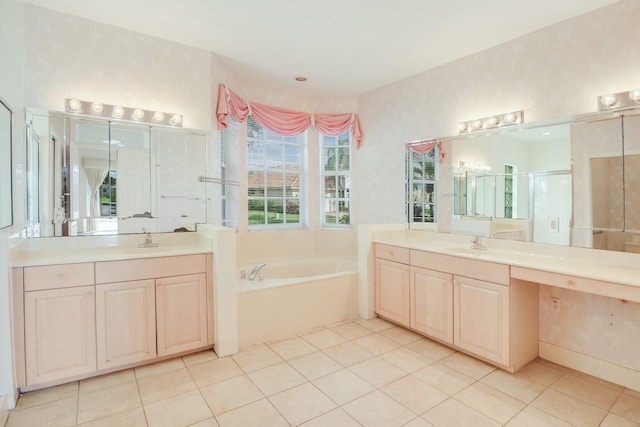 bathroom featuring plus walk in shower, vanity, and tile patterned floors