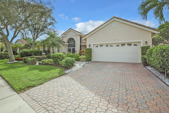 view of front of house with a garage and a front yard