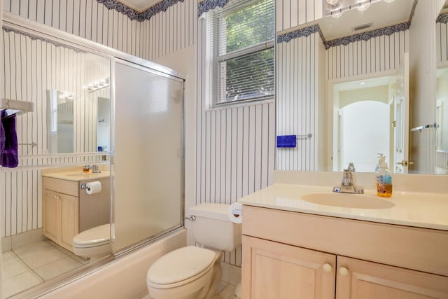 full bathroom with tile patterned floors, vanity, toilet, and shower / bath combination with glass door