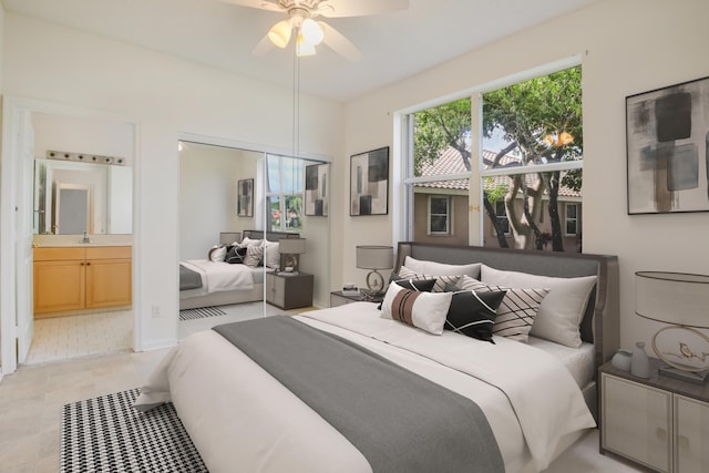 bedroom with ensuite bathroom, ceiling fan, light tile patterned floors, and sink