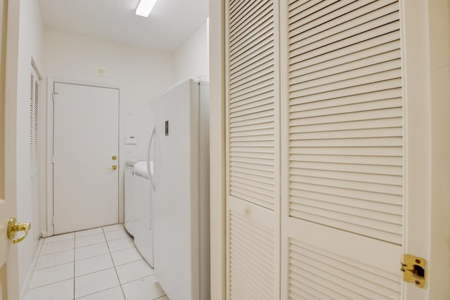 laundry room featuring washer and dryer and light tile patterned flooring