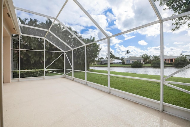 unfurnished sunroom featuring a water view