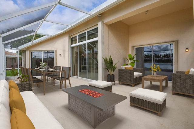 view of patio with glass enclosure and an outdoor living space with a fire pit