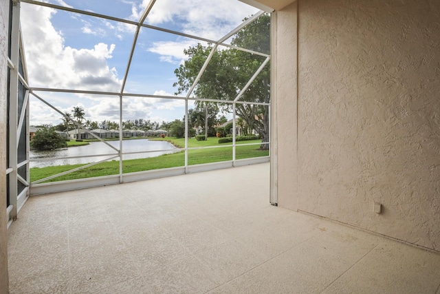 unfurnished sunroom featuring a water view