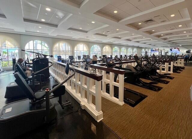 workout area featuring coffered ceiling