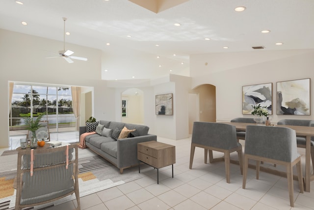 living room with ceiling fan, light tile patterned floors, and high vaulted ceiling