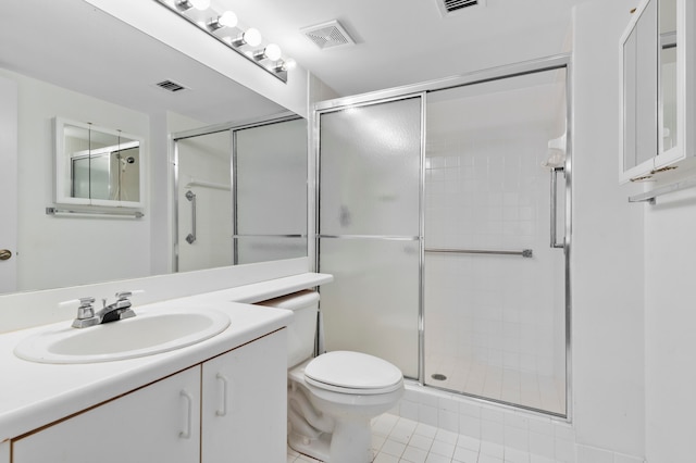 bathroom with vanity, a shower with shower door, tile patterned flooring, and toilet