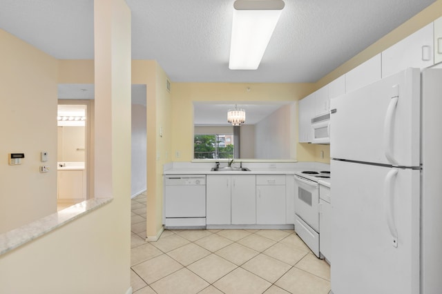 kitchen featuring white appliances, pendant lighting, sink, white cabinets, and a chandelier